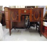 An Edwardian inlaid mahogany side table with a drawer and two doors, on square tapered legs and