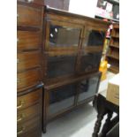 An early 20th century Minty style oak three section bookcase with glass doors on turned feet 123cm h