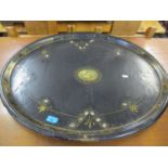 A Victorian black papermache tray with mother of pearl inlay and a central motif depicting a young