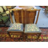 Two late Georgian dining chairs with pierced central splats, tapestry upholstered drop-in seats,