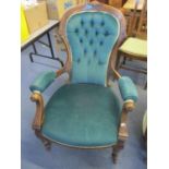 A Victorian walnut salon armchair having button back upholstery and turned front legs