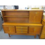 A mid 20th century retro teak highboard having open shelves, a fall flap, three drawers and a