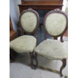 A pair of Victorian mahogany framed balloon back dining chairs