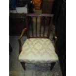 A late 18th century mahogany carved splat back dining chair with open arms, on square legs