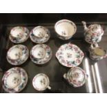 A Victorian dolls part tea set decorated with flowering vines, comprising six cups, five saucers,