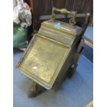 A Victorian brass coal bucket having a carrying handle and on wheels