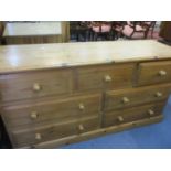 A late 20th century pine chest of three short drawers above four drawers 78h x 151w x 49cm d