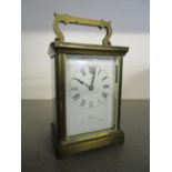 A French fire window brass cased carriage clock retailed by Asprey London, with key