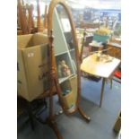 A mahogany framed Cheval mirror with floral painted decoration, brass caps and casters to splayed