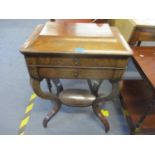 A Victorian walnut work table having a hinged top revealing fitted compartments above a single