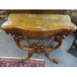 A Victorian walnut foldover card table having scroll shape supports on a quatrefoil base 73cm h x 92