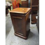 A Victorian mahogany bedside cabinet with a panelled door