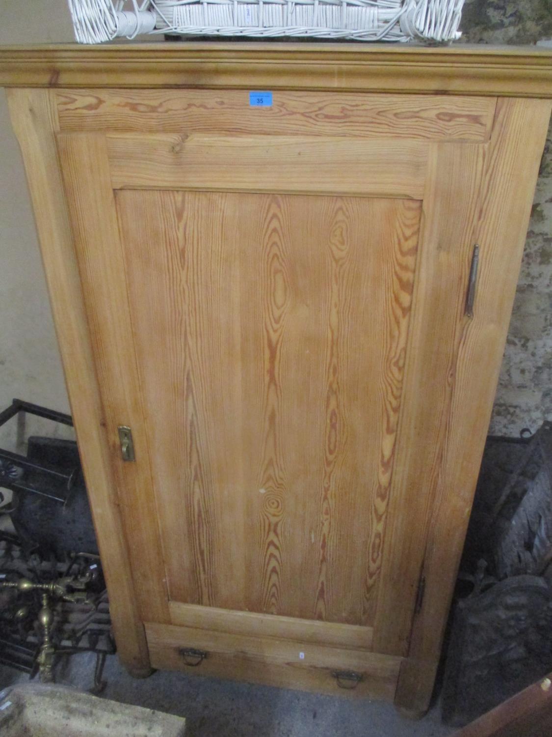 A reproduction pitch pine single door armoire with single drawer below, 175cm h x 102cm w