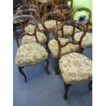 A set of eight Victorian walnut dining chairs on front cabriole legs