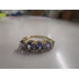 9ct yellow gold ring set with oval-cut tanzanites and round-ct white sapphires