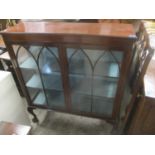 An early 20th century mahogany two door glazed bookcase standing on ball and claw feet 122h x