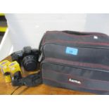 A Canon EOS, 1000F, camera with a Sigma lens, a travel bag and accessories