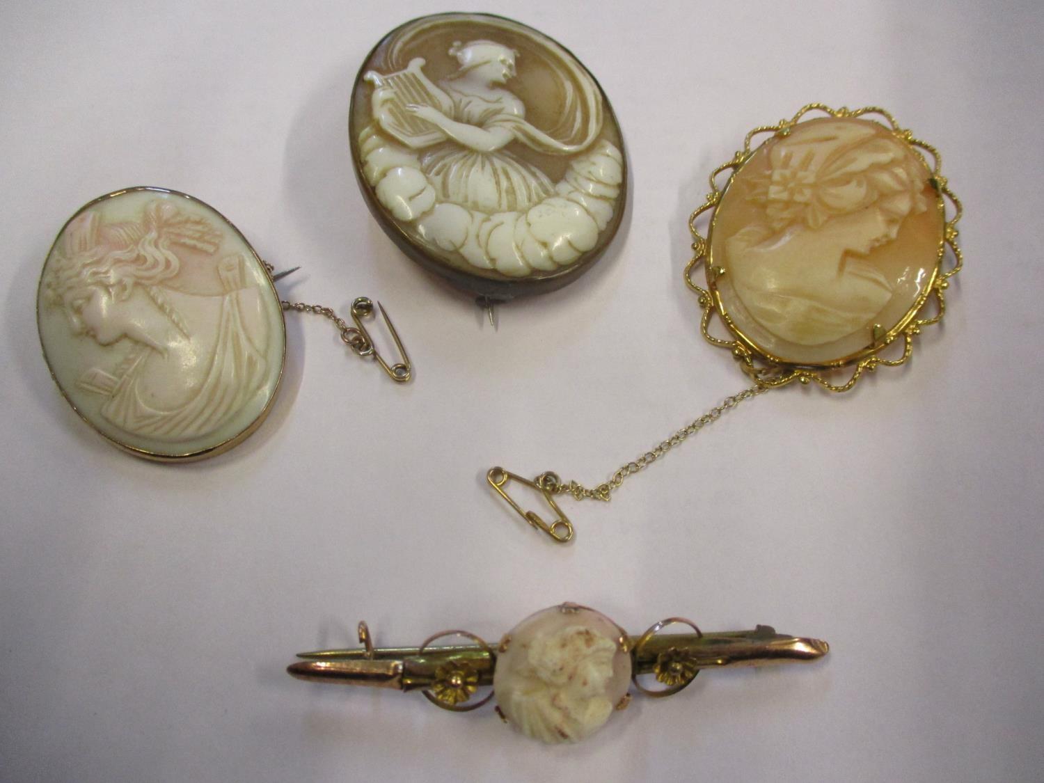 A 9ct gold and cameo bar brooch together with three cameo brooches