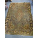 A Persian hand woven rug having central medallion and a floral design 190cm x 132cm A/F