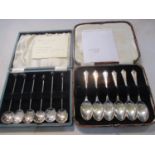 A cased set of six 1930's silver bean spoons and a cased set of six 1930's teaspoons, total weight