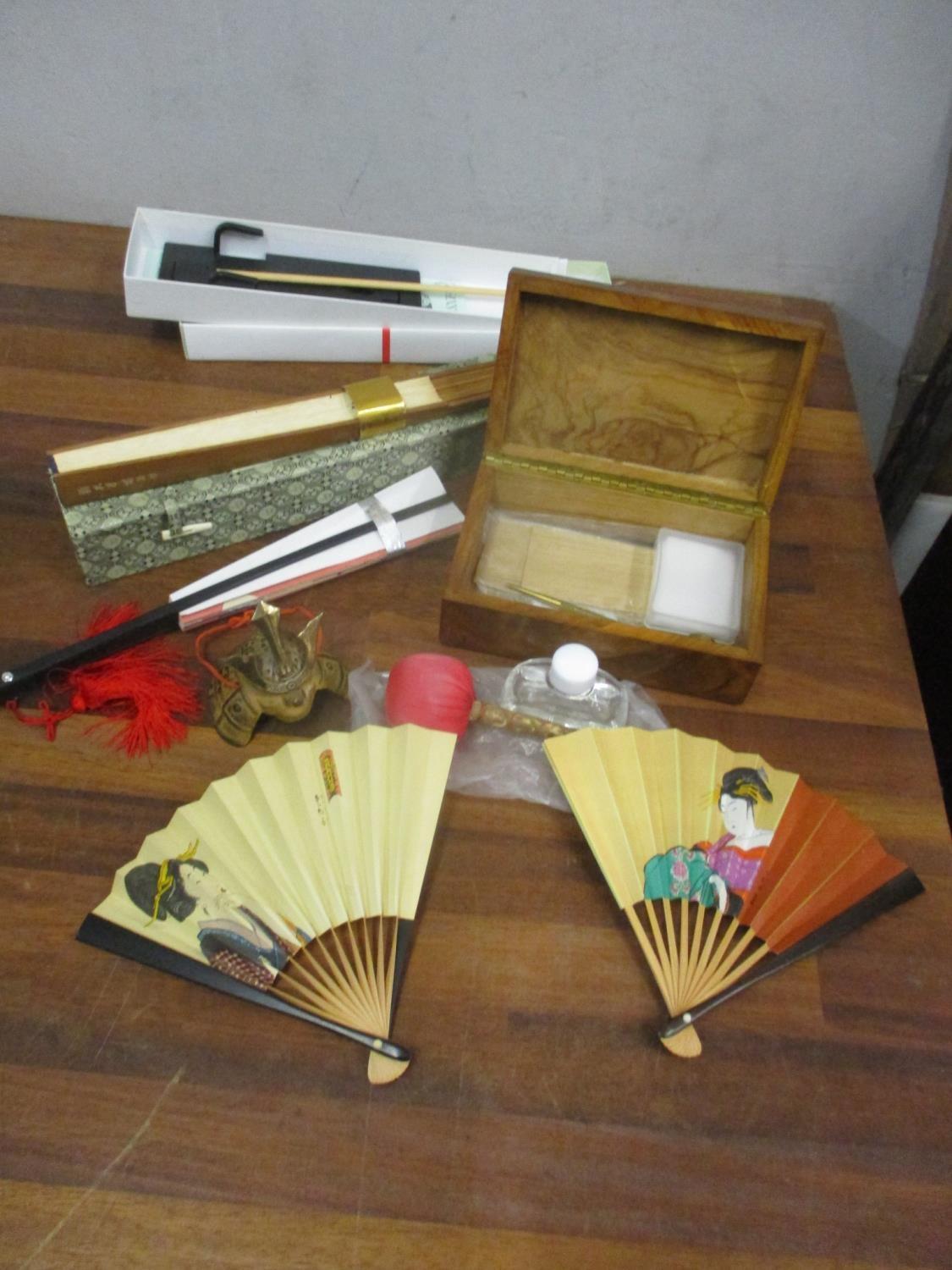 Mixed oriental items to include fans and Samurai helmet ornaments