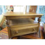 An Ercol corner table with hinged rear flap and central drawer