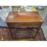 A reproduction mahogany two drawer side table with brushing slide on octagonal tapering legs