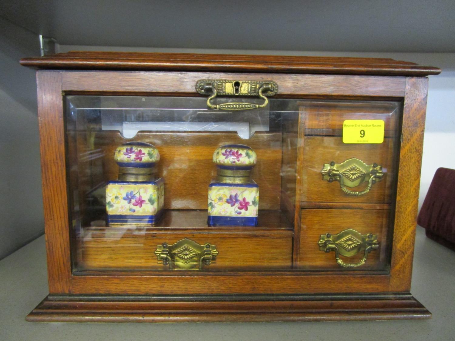 A Victorian oak stationery box with hinged lid and glazed fall front, fitted interior with three