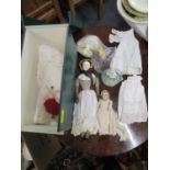 A Victorian porcelain headed doll with fabric body and kid leather arms, along with linen and lace