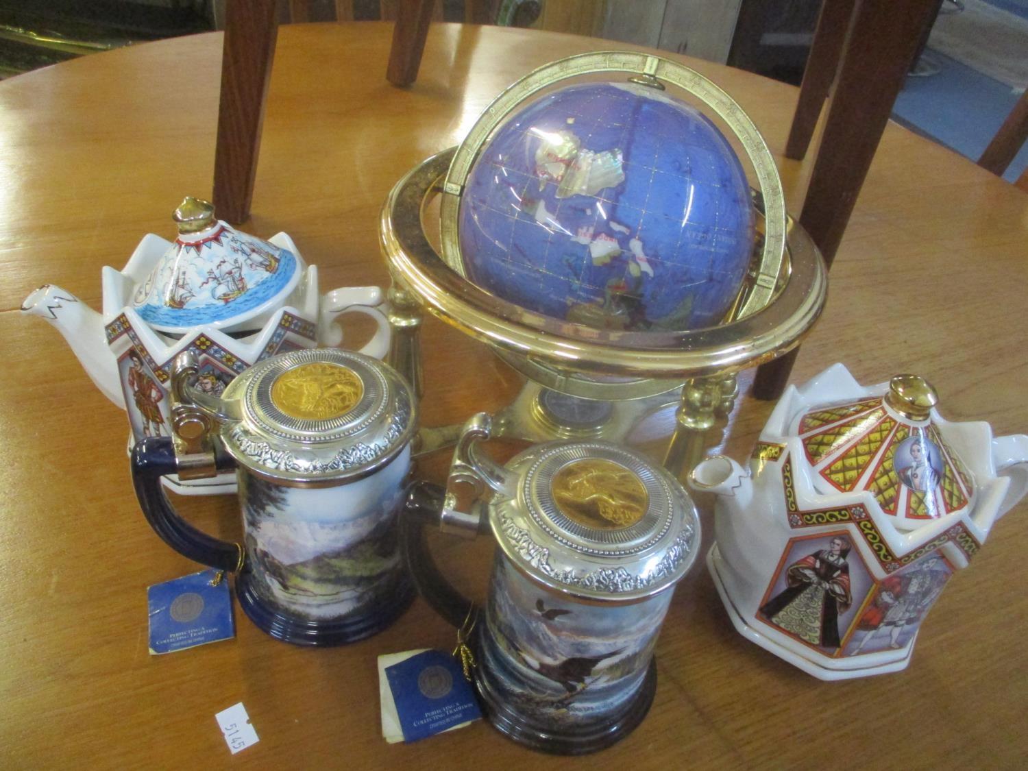 A desk top globe inset with semi-precious stones, two Franklin Mint tankards and two Sadler teapots