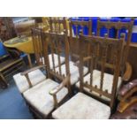 Four Ercol dining chairs and two matching carvers together with an Ercol D-ended and extending