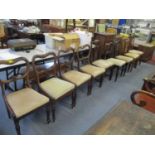 A matched set of six William IV kidney back chairs with turned front legs and upholstered drop in