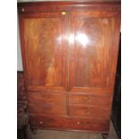 An early Victorian linen press, twin doors with interior converted to a wardrobe above drawers, on