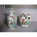 A Chinese canton celadon glazed vase decorated with a bird and butterfly and floral designs, along