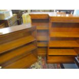 A pair of reproduction yew bookcases with three adjustable shelves