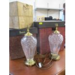 A pair of Waterford cut crystal glass and brass table lamps together with two Harrods hamper boxes
