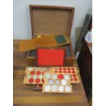 A mahogany collectors' box and coin box housing mixed Crowns