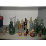 A collection of glass bottles, chemical measures, inkwells and stoneware bottles and pots