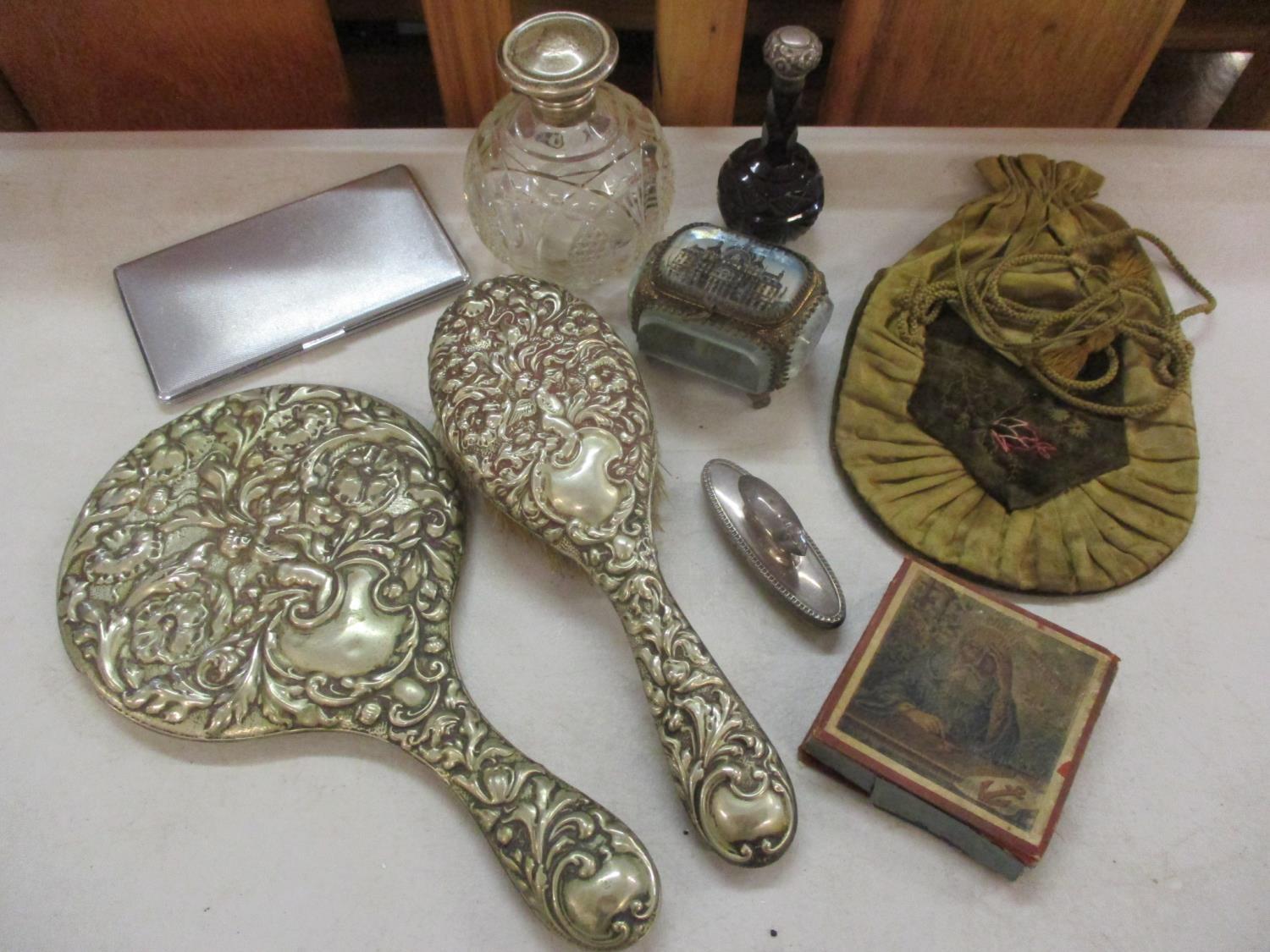 A sterling silver topped and cut-glass perfume bottle and another together with a small silver