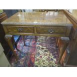 A mid 20th century burr walnut veneered side table having two inset drawers and standing on pad