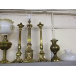 A brass column table lamp, a pair of brass column candlesticks and two oil lamps with shades A/F