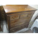 A Georgian mahogany chest of drawers having a dental moulded cornice, three short drawers, three