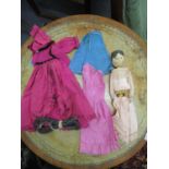 A 19th century Grodnertal wooden peg doll with dresses and undergarments