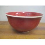 A Derek Emms porcelain bowl in oxblood glaze