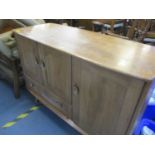 An Ercol sideboard on splayed legs