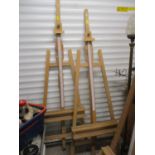 A pair of modern light wooden artists easels