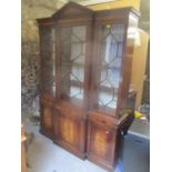 A reproduction Brights of Nettlebed breakfront display cabinet having a dental moulded cornice,