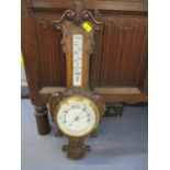 A carved oak framed Victorian wall barometer
