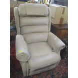 A beige upholstered electric reclining armchair