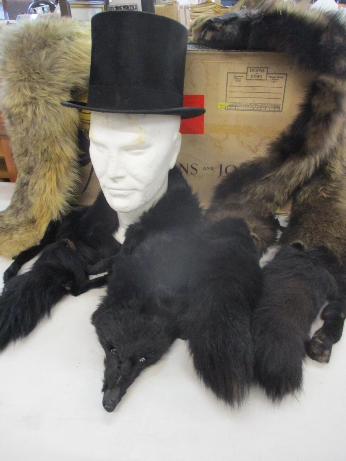 A G.A. Dunn silk felt top hat 19cm front to back, 15.25cm side to side, together with two fox stoles